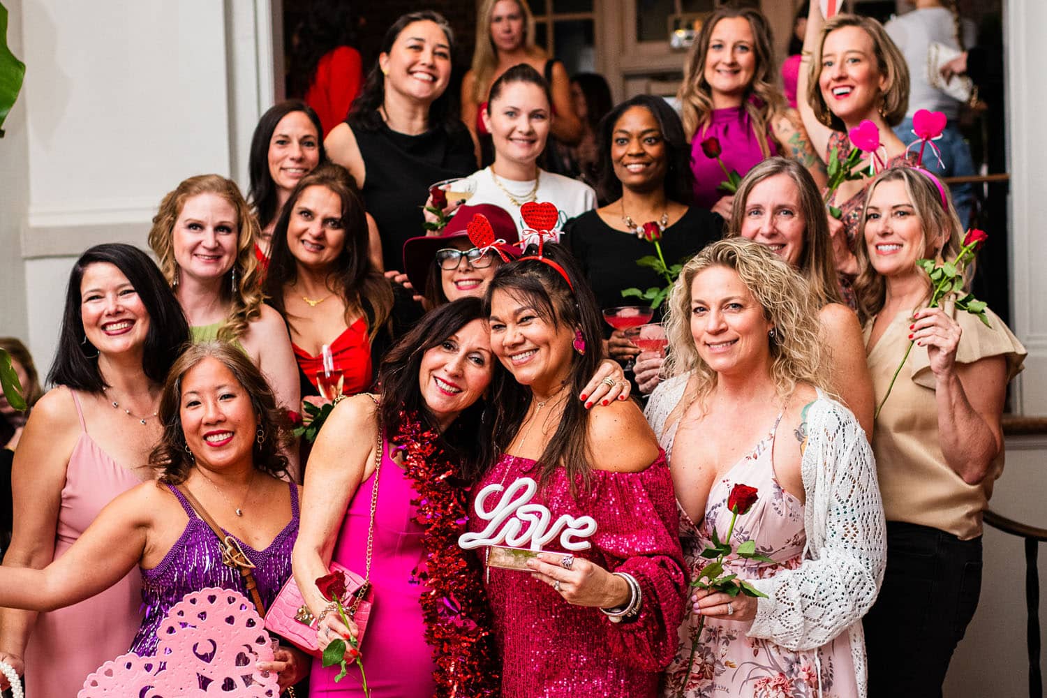 A group of friends posing for a photo at a Valentine's Day event