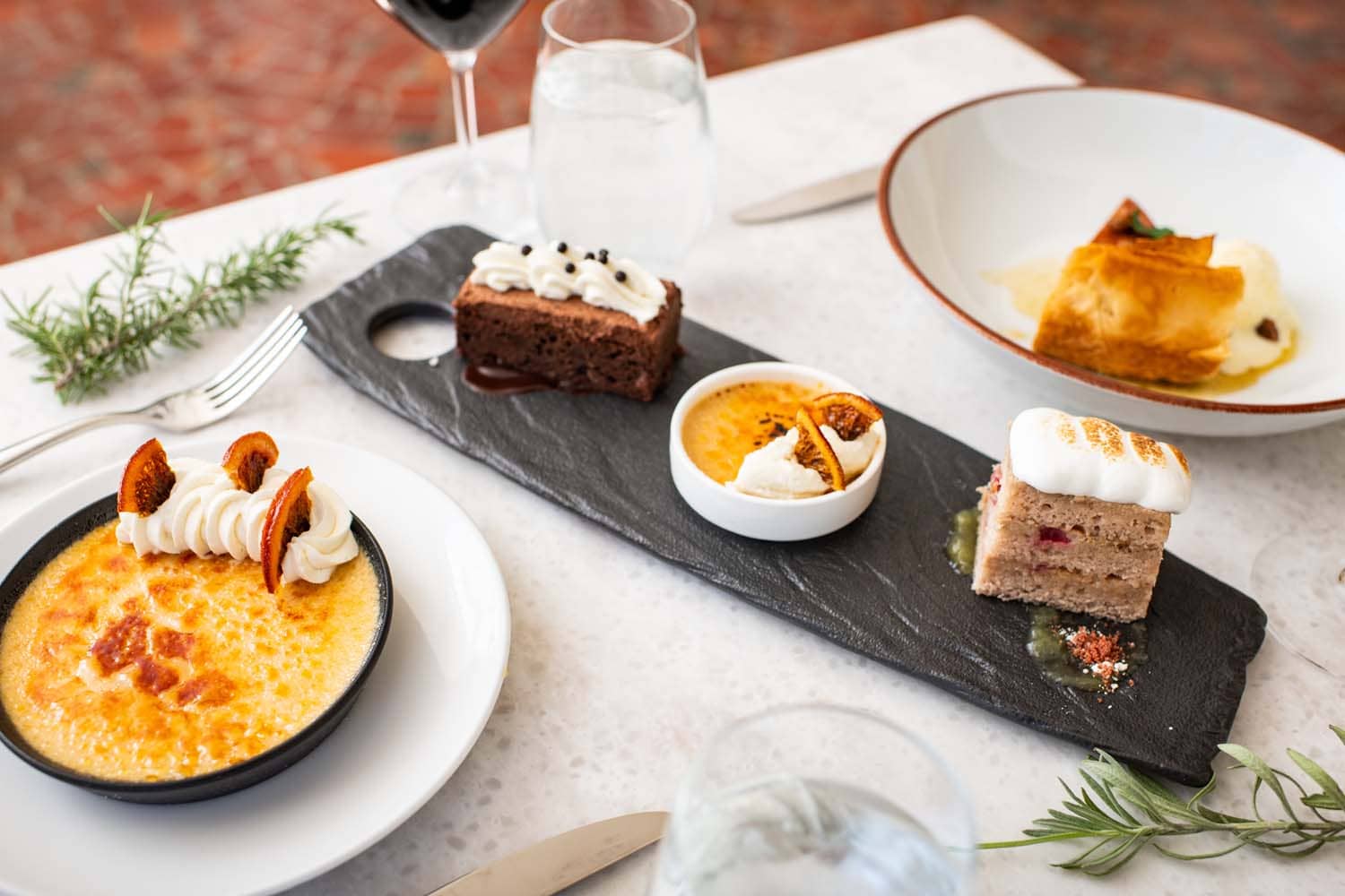 A spread of desserts on a table at Becca Restaurant & Garden