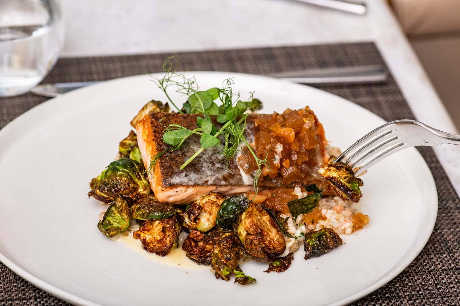 A plated seafood meal on a table at Becca Restaurant & Garden