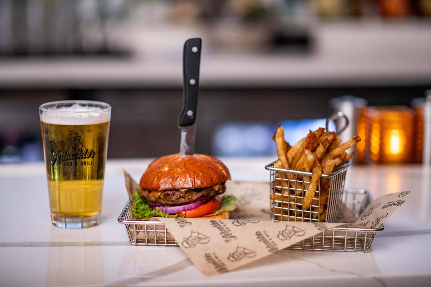 A close-up hamburger on a table at Arbuckle's Bar & Grill