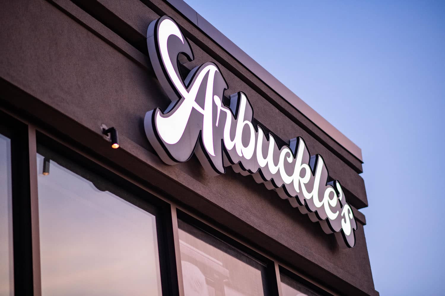 The exterior sign at Arbuckle's Bar & Grill at sunrise