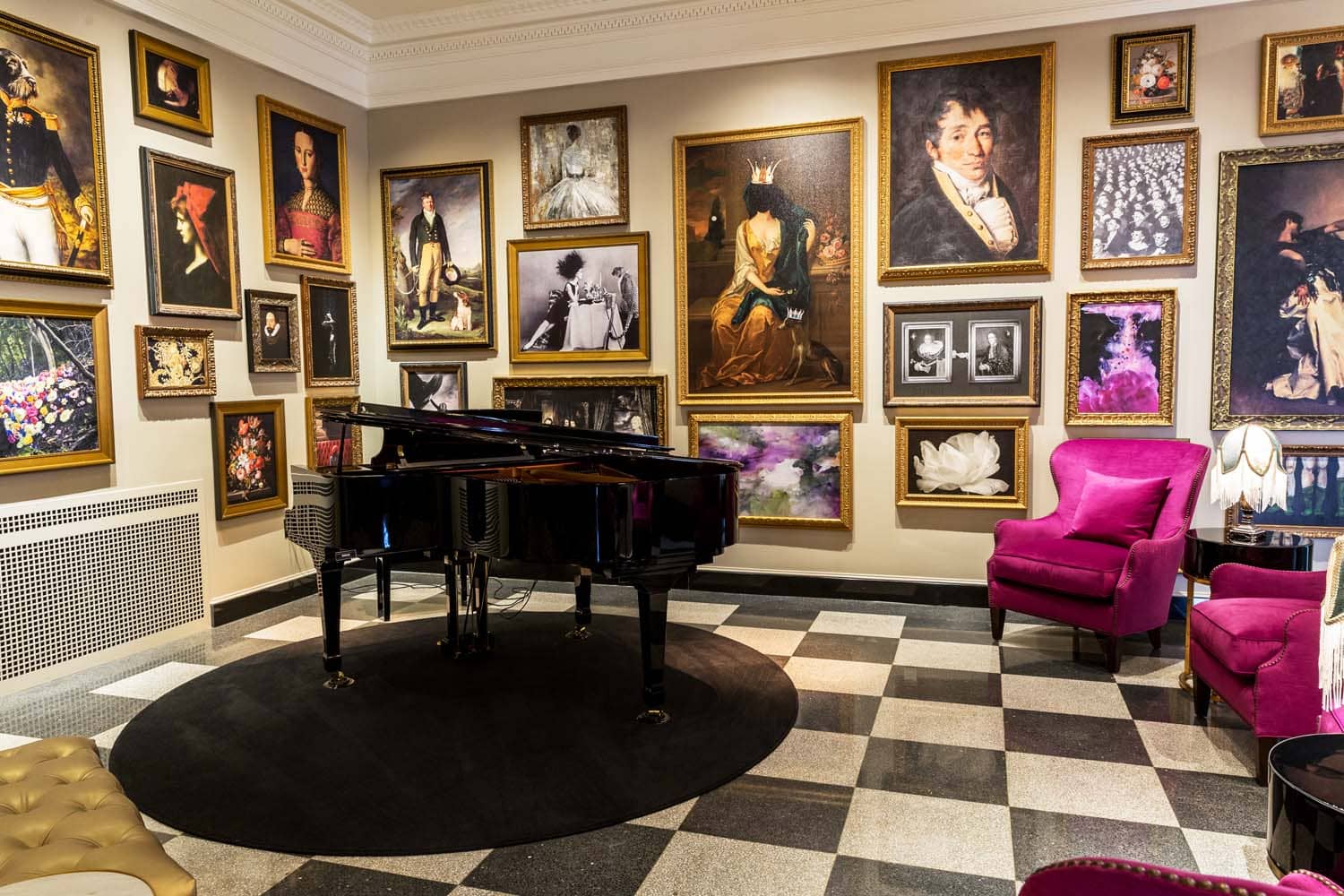 The interior lounge with artwork and a piano inside The Raleigh Room