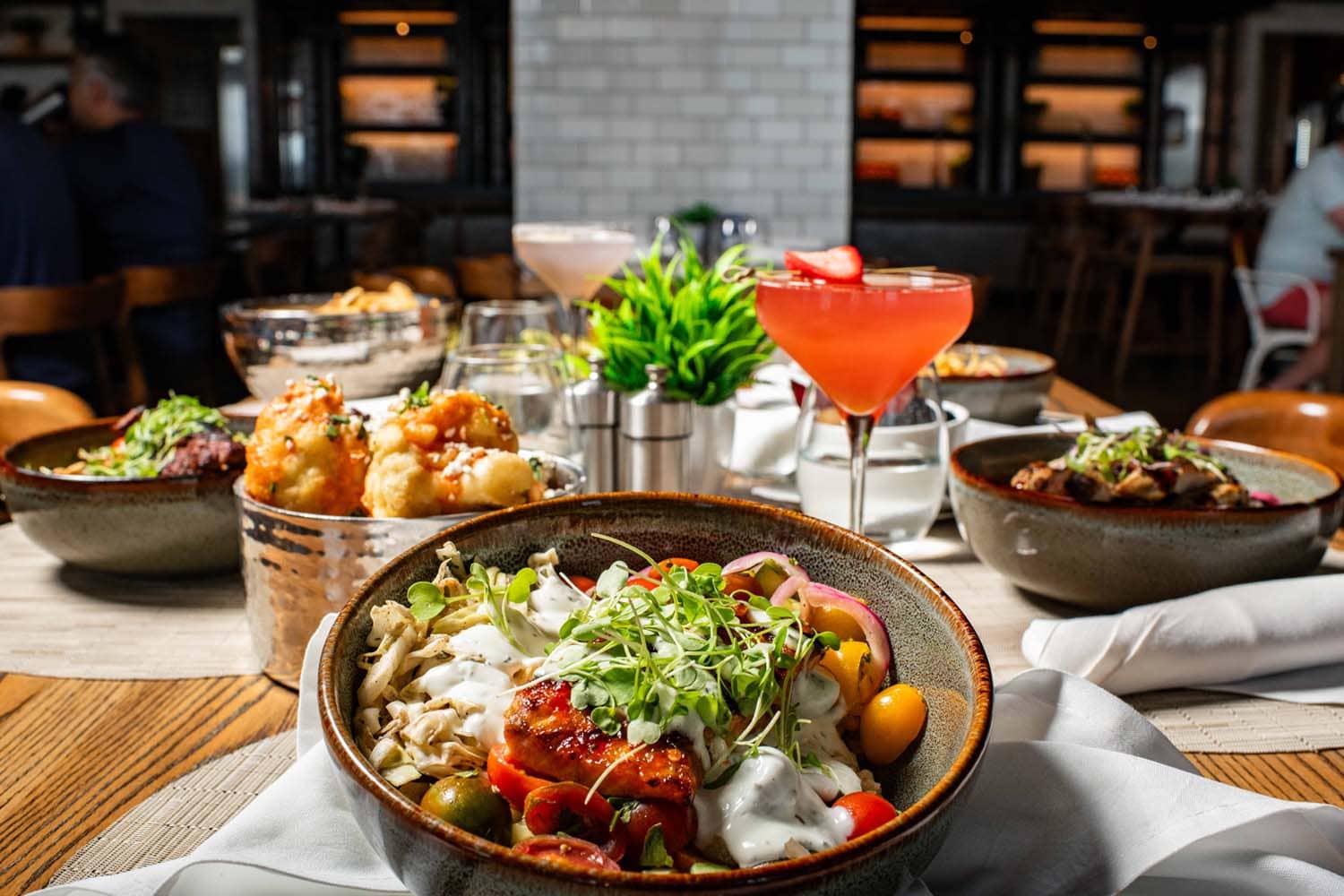 A variety of plated dishes on a table at Tulu Seaside Bar & Grill