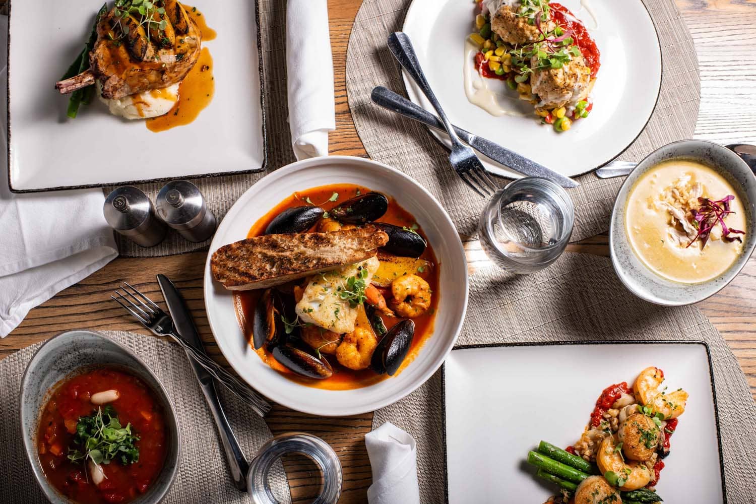 A variety of plated dishes on a table at Tulu Seaside Bar & Grill