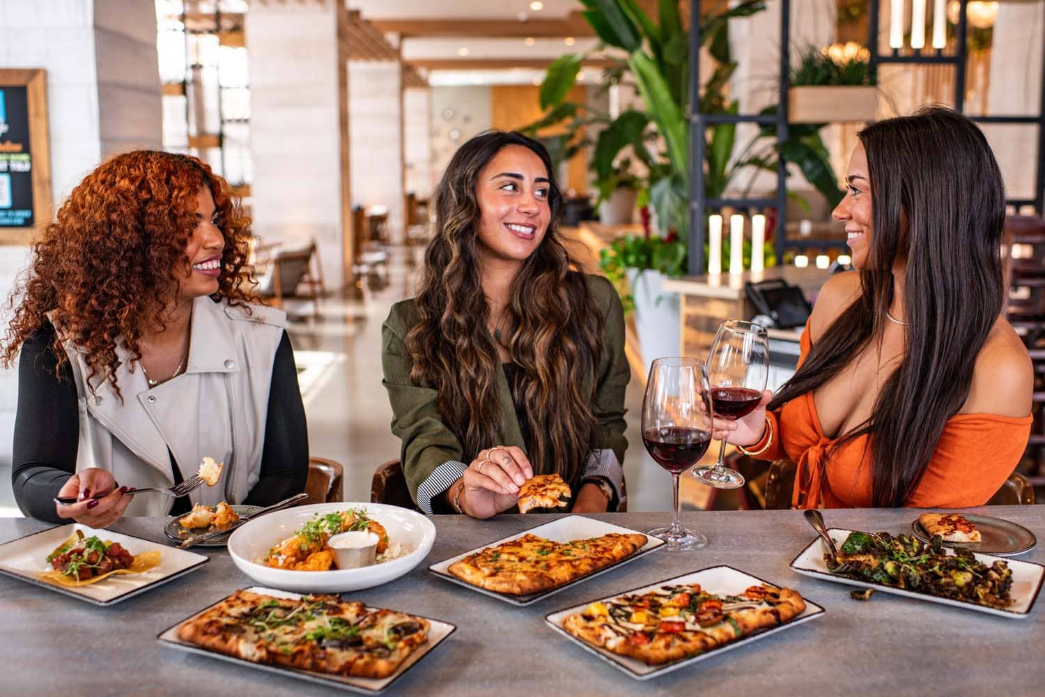 A group of women eating a meal inside Tulu Seaside Bar & Grill