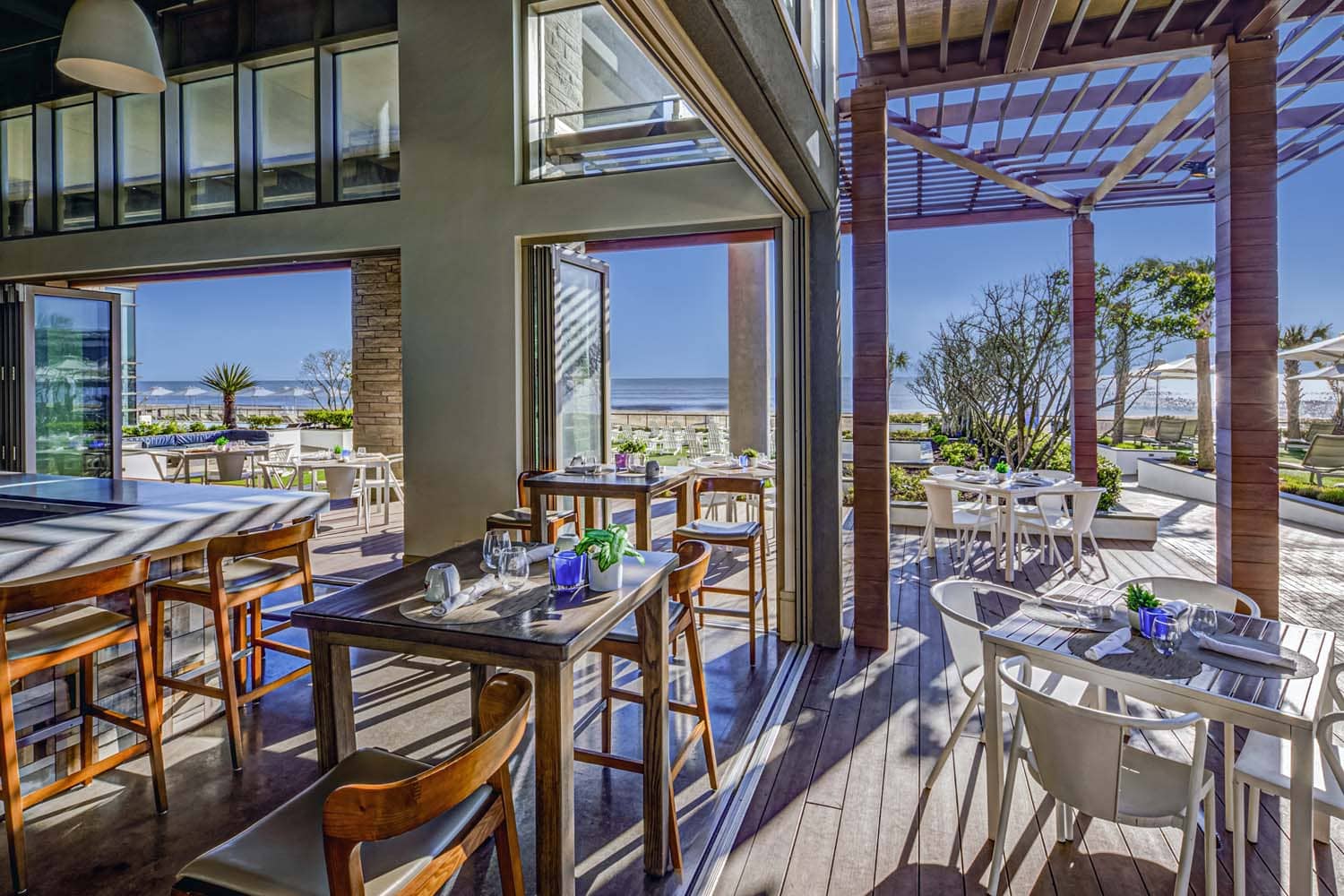 The interior dining area with patio views and seating at Tulu Seaside Bar & Grill