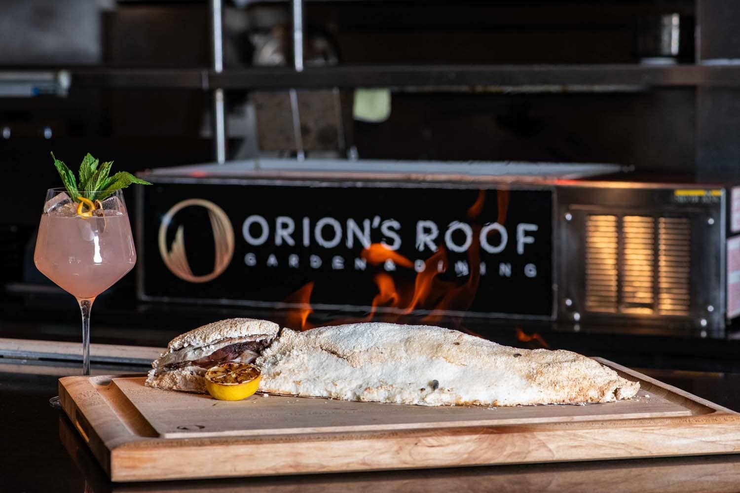 A whole fish flame dish on a table at Orion's Roof