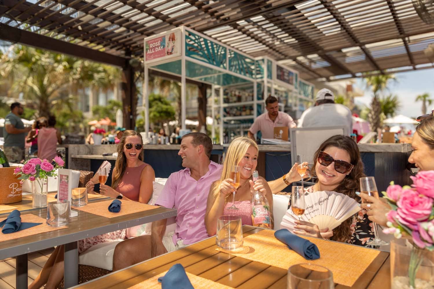 A group of four people enjoying the seating area at The Deck Seaside Bar & Grill