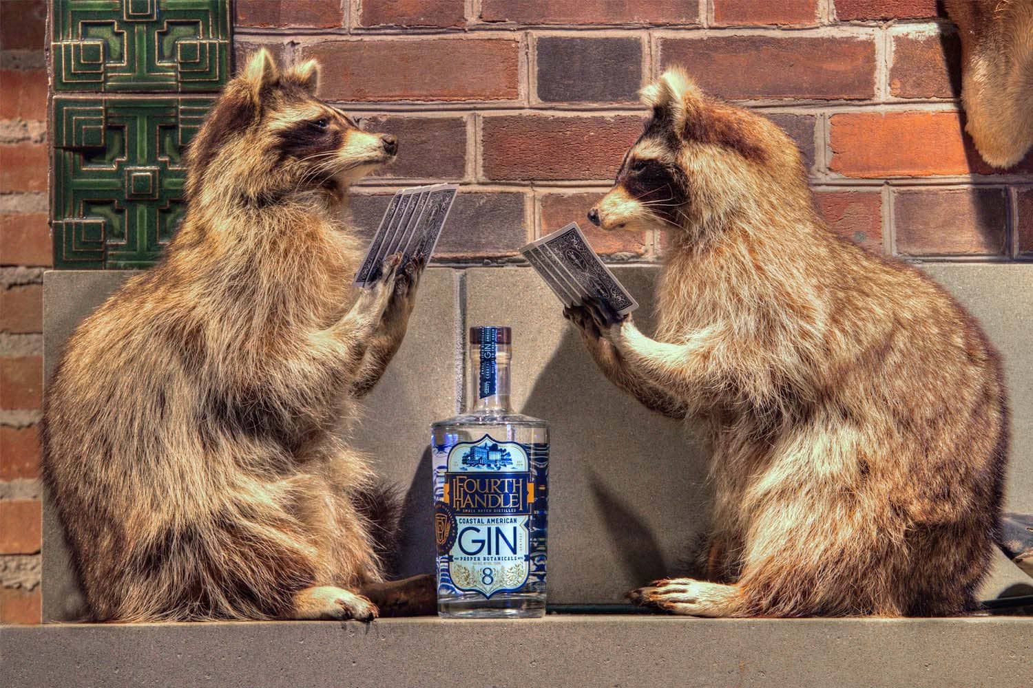 Two stuffed raccoon's playing cards on display inside the Hunt Room