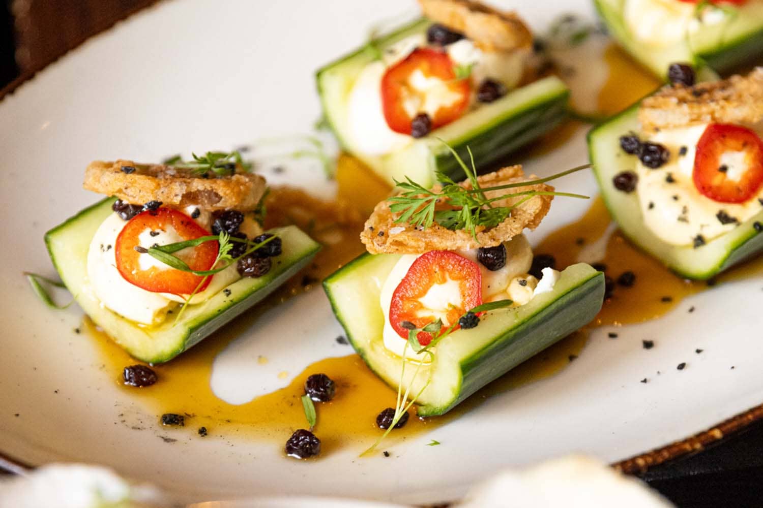 A close-up view of a plated appetizer dish on a table at the Hunt Room
