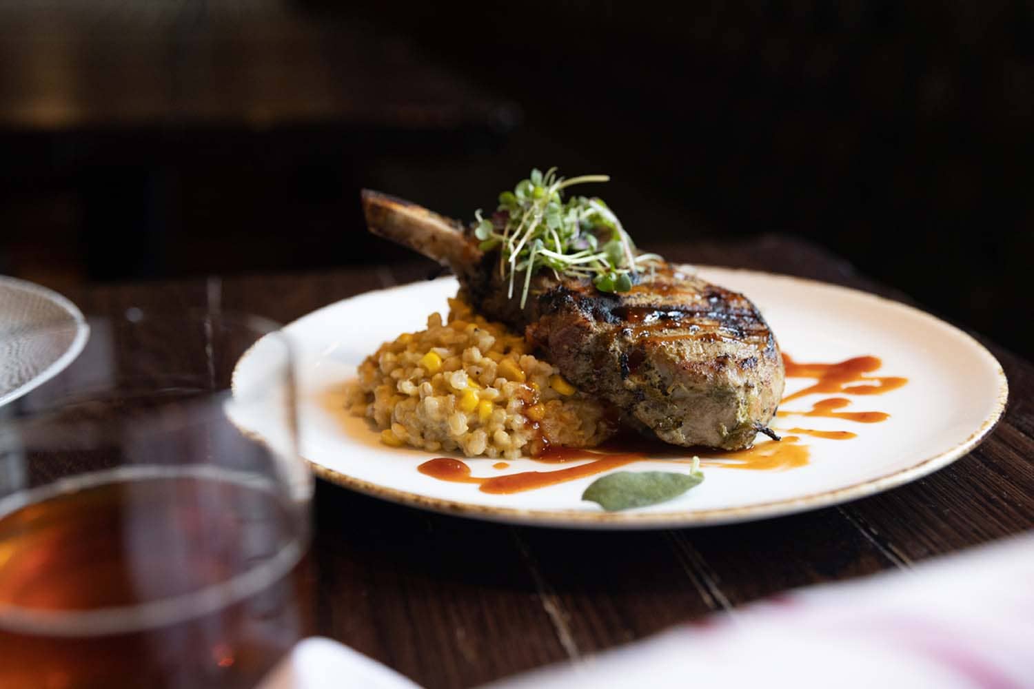 A plated porkchop dish on a table at the Hunt Room