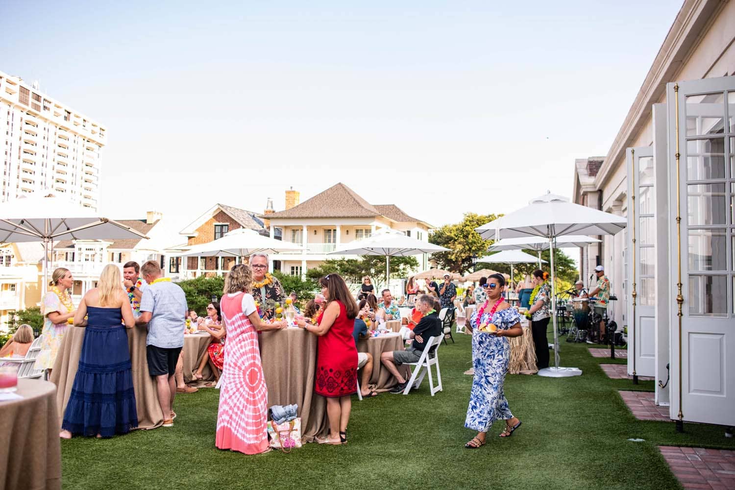 A group of people eating and drinking on the Cavalier Great Lawn in summer