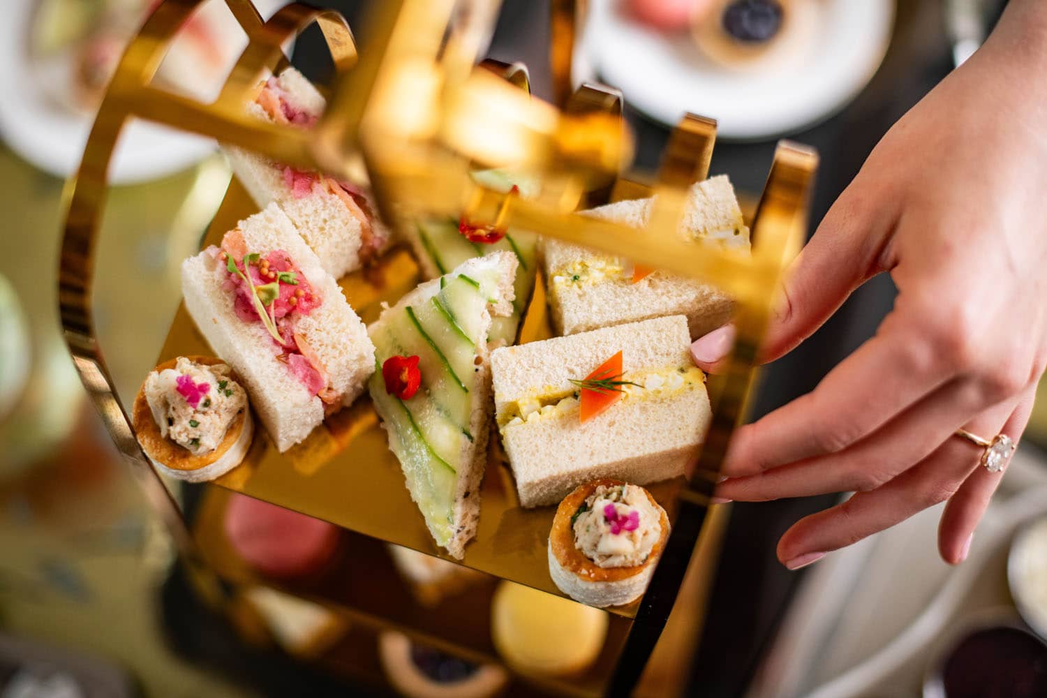 A close-up view of finger sandwiches on a tray