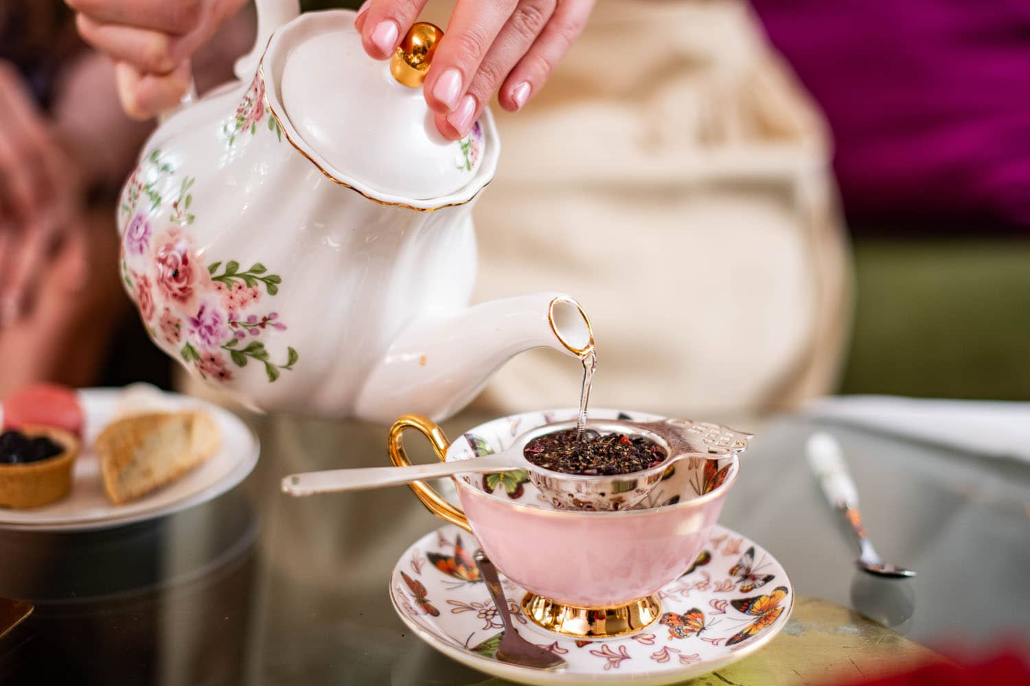A tea kettle and teacup on a table inside The Raleigh Room