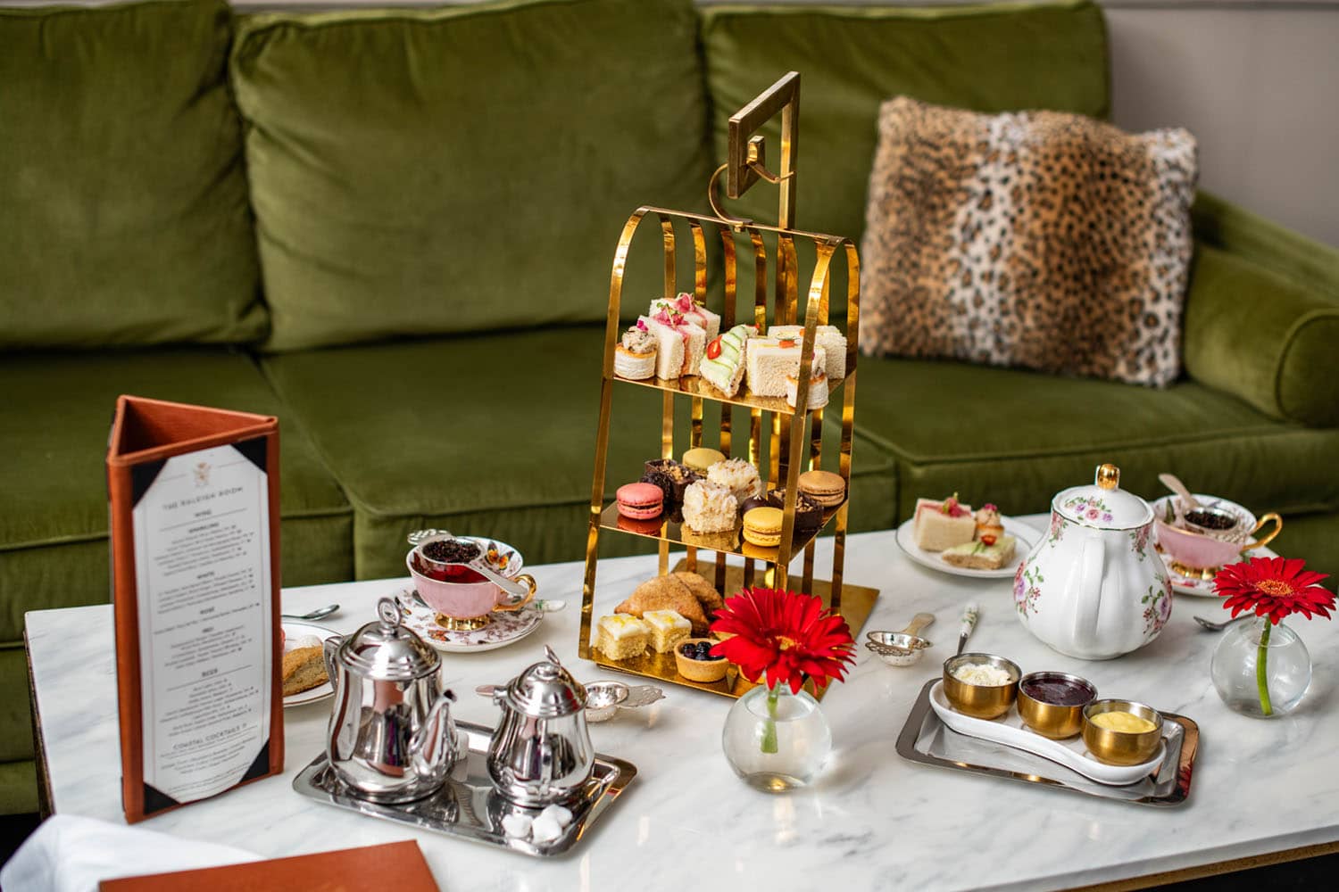 A plated assortment of tea and small plates on a table inside The Raleigh Room restaurant