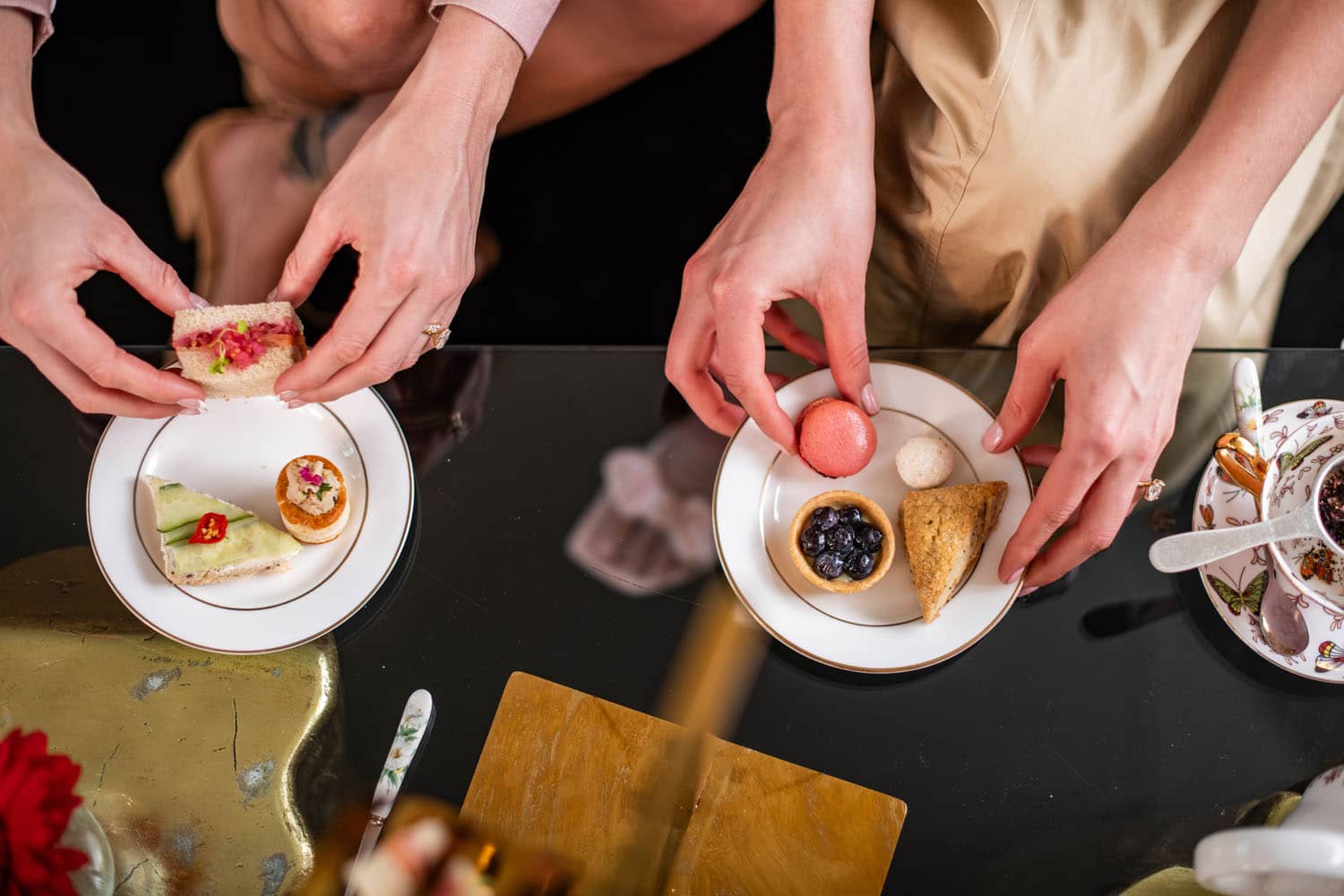 Two small plate dishes being held next to a table at The Raleigh Room