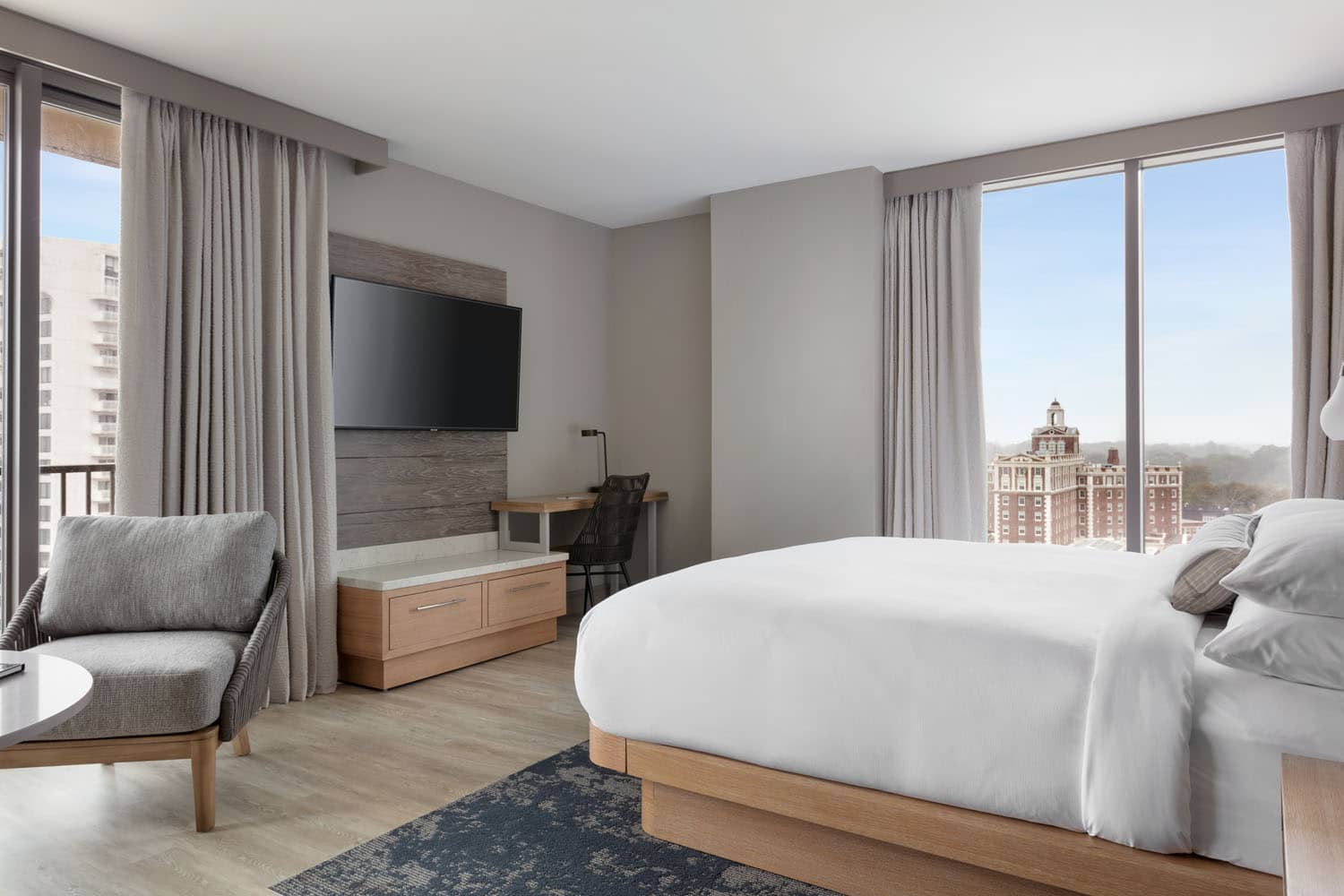 A junior suite guest room with views of The Cavalier Hotel from inside the Marriott Virginia Beach Oceanfront Resort