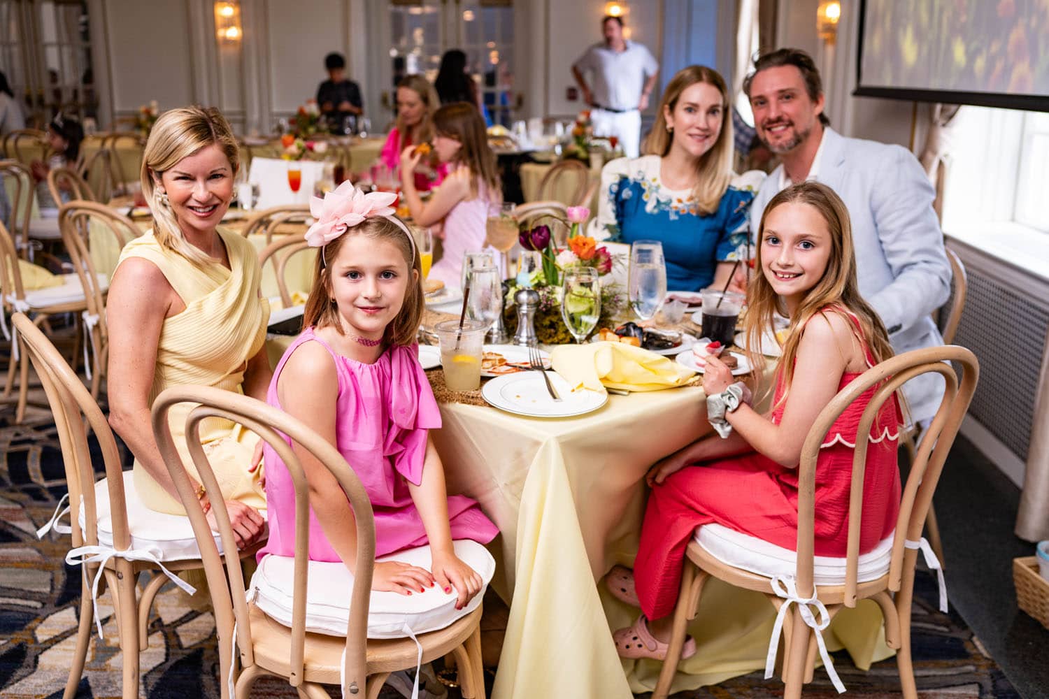 A family at a table inside the Crystal Ballroom Easter Buffet