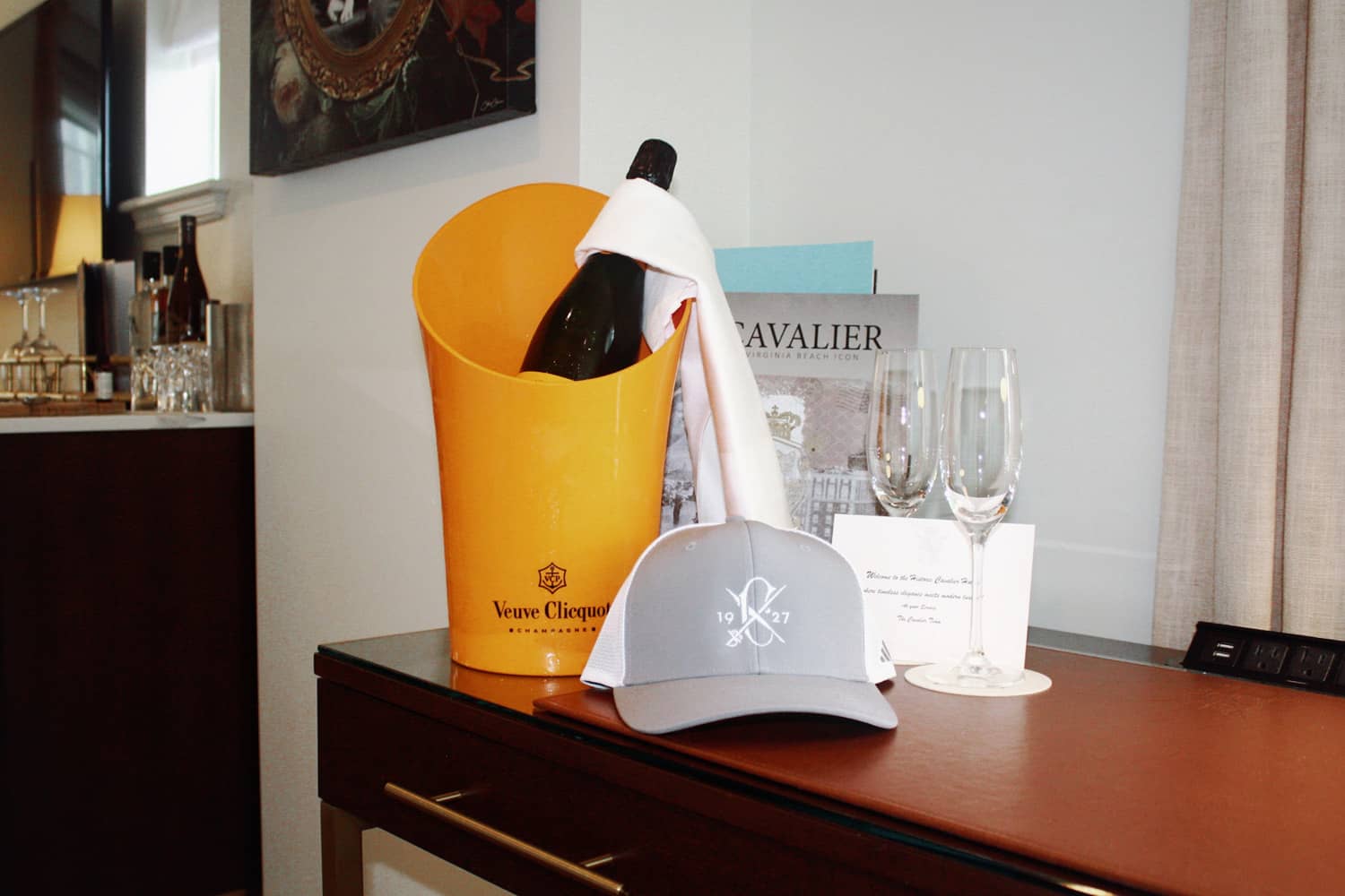 An amenity gift of champagne and snacks on a table at The Cavalier Hotel