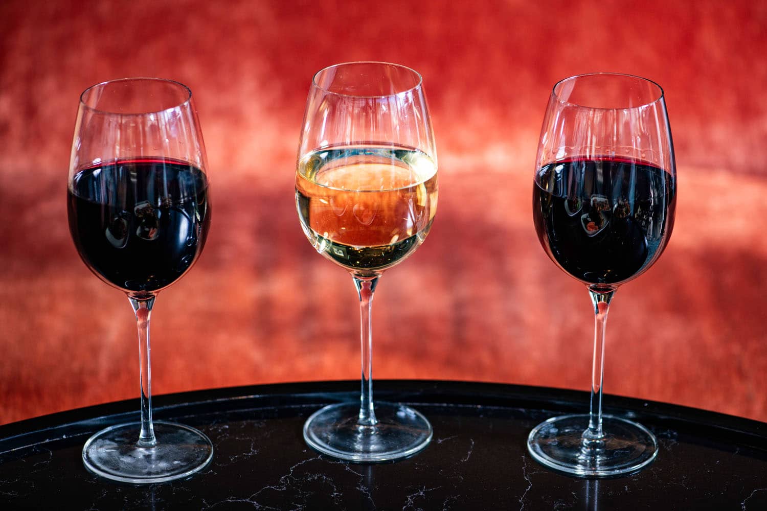 Glasses of red and white wine on a table