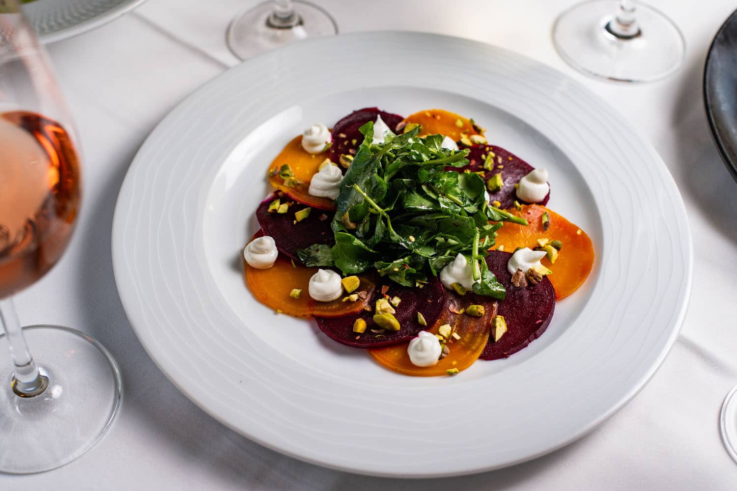 A plated salad dish on a table at Becca Restaurant & Garden