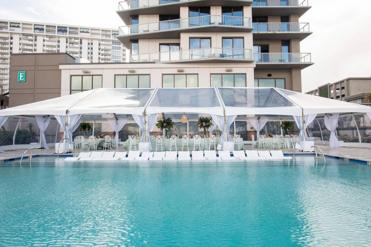 The outdoor pool deck with a tent for events at the Embassy Suites Virginia Beach Oceanfront Resort