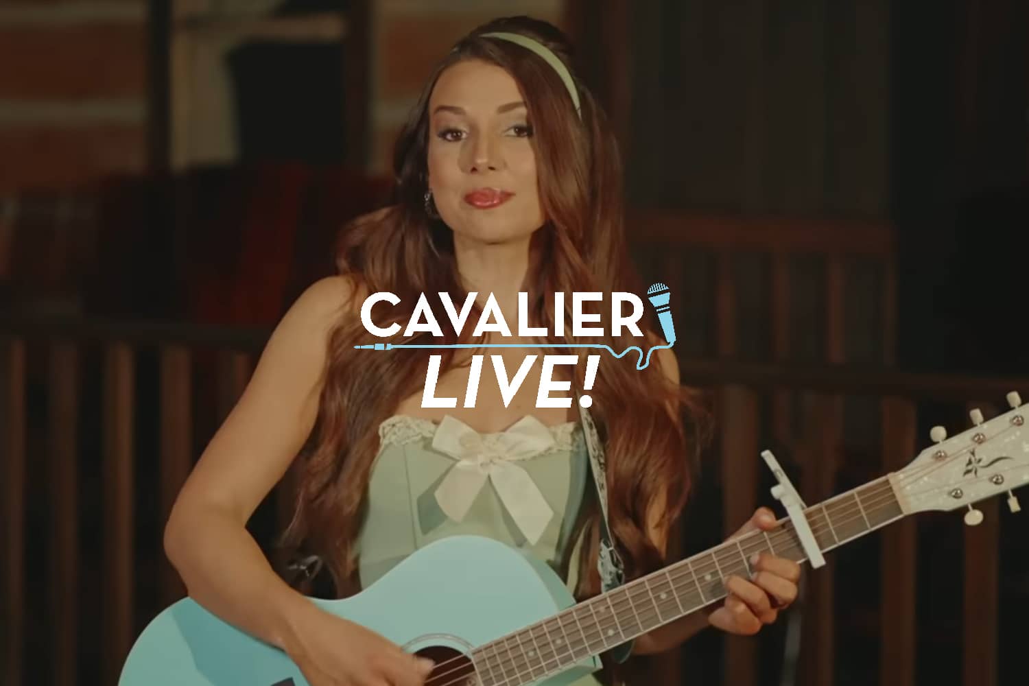 Artist Kaylee Rose posing for a photo holding a guitar