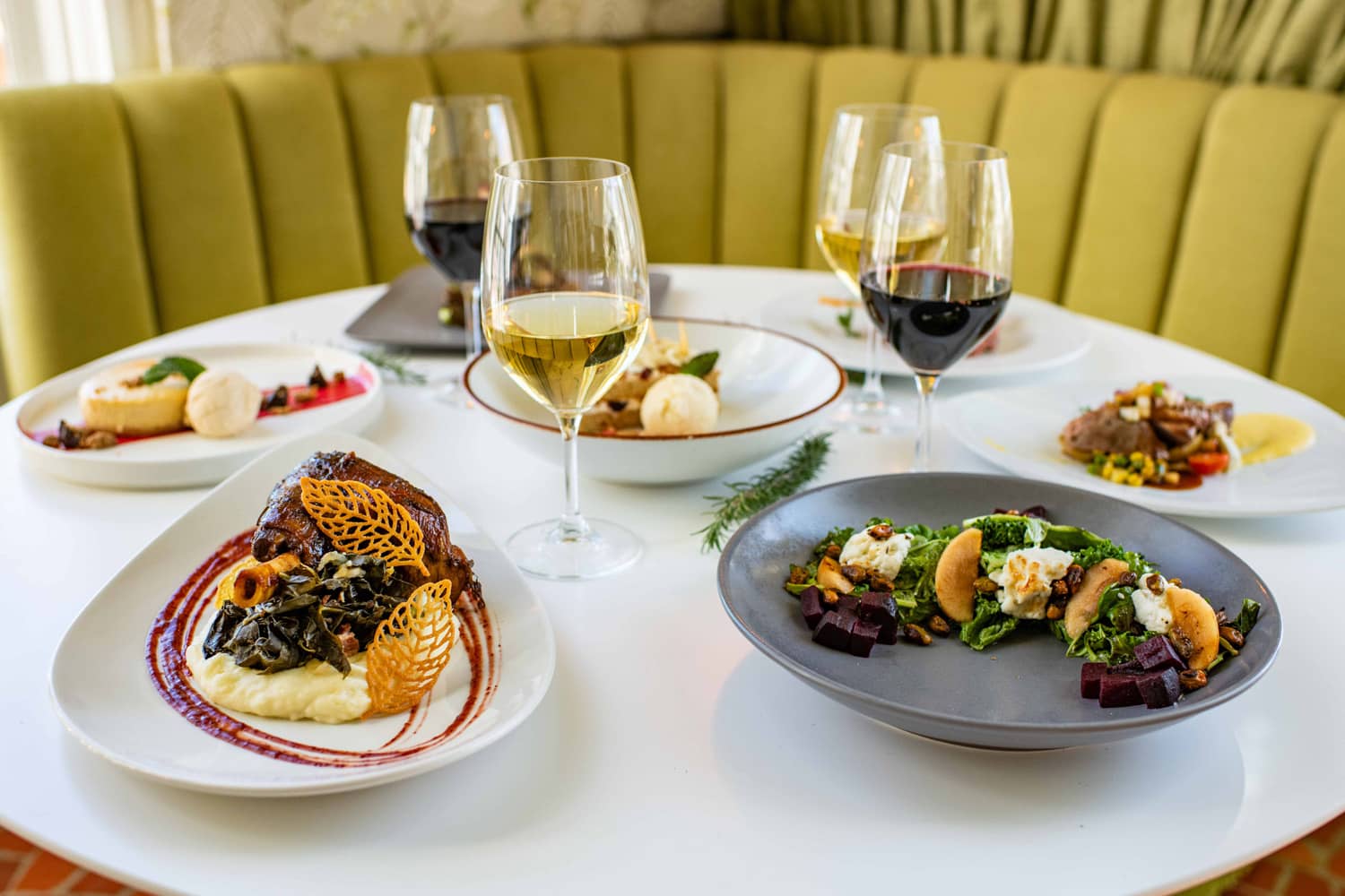 A sample of plated dishes on a table at Becca Restaurant & Garden