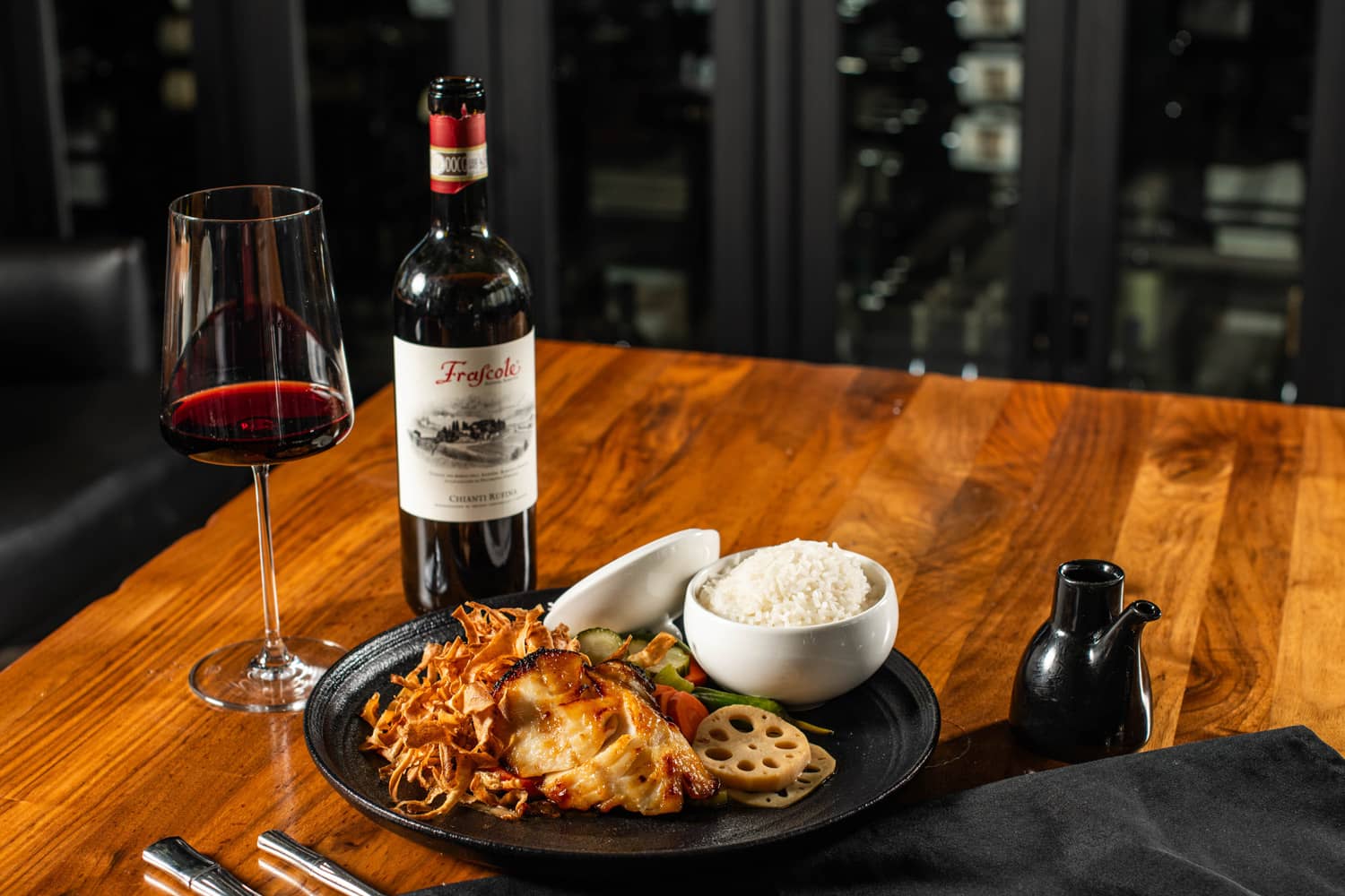A wine and fish meal on a table at Orion's Roof